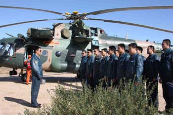 A colonel of special rescuing helicopters team addresses a mobilizing ceremony in the area awaiting for emergency missions of the main landing field of the Shenzhou-7 spacecraft in Siziwang Banner (county), north China's Inner Mongolia Autonomous Region, where the spacecraft is expected to land as it returns to the earth, on Sept. 26, 2008. [Xinhua]