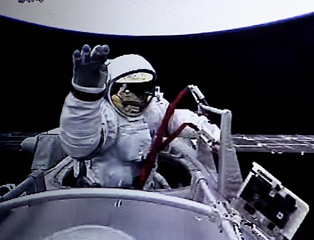 The video grab taken at the Beijing Space Command and Control Center on Sept. 27, 2008 shows Chinese taikonaut Zhai Zhigang waving while walking out of the orbit module of the Shenzhou-7 spacecraft. 