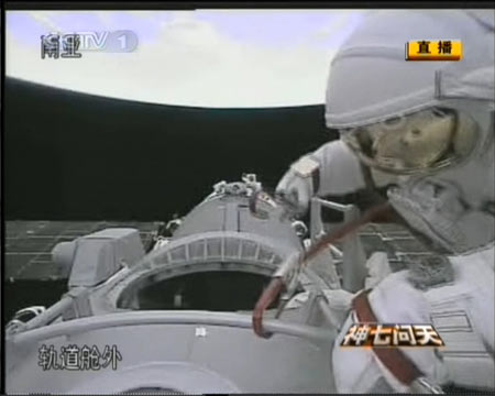 The video grab taken on Sept. 27, 2008 in Beijing, China, shows Chinese taikonaut Zhai Zhigang slipping out of the orbital module of Shenzhou-7, starting China&apos;s first spacewalk in the outer space. 
