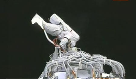 The video grab taken on Sept. 27, 2008 in Beijing, China, shows Chinese taikonaut Zhai Zhigang getting the test sample of solid lubricant placed outside the orbital module.