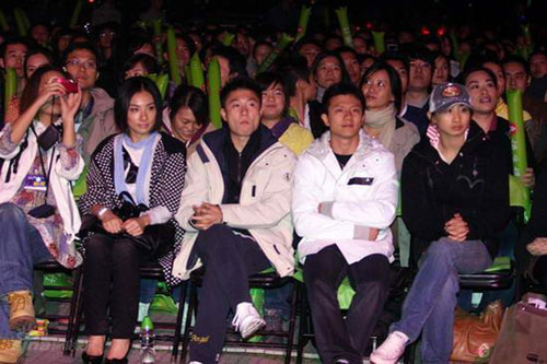 Olympic gymnastic champions Liu Xuan, Li Xiaopeng, Chen Yibing (2nd to 4th from left, front) watch Eason Chan's concert at the Beijing Worker's Stadium on Sunday, September 28, 2008.
