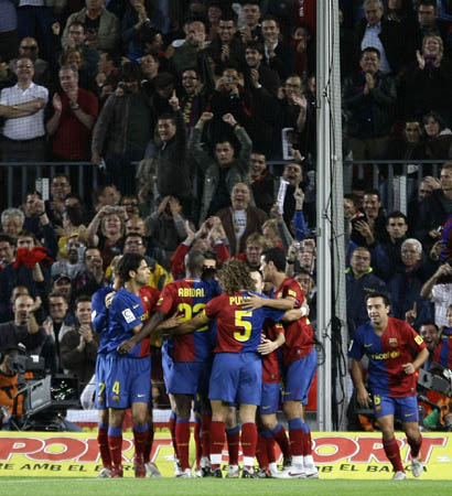 Barcelona's players celebrates Lionel Messi's goal against Atletico de Madrid during their Spanish first division soccer match at Nou Camp stadium in Barcelona, October 4, 2008.