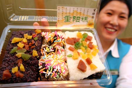 A food shop assistant shows the cake for the Double Ninth Festival, in Beijing, capital of China, Oct. 5, 2008. The Double Ninth Festival, known as the "Chongyang Festival" which is a traditional Chinese occasion to pay respect to the aged, is marked on the ninth day of the ninth month of the Chinese lunar calendar, or Oct. 7 this year.