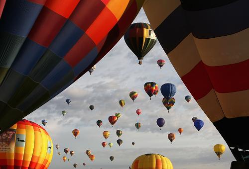 Hor air balloons soar over Balloon Fiesta Park during the Albuquerque International Balloon Fiesta on October 4, 2008. This year there are over 600 hot air balloons, representing 42 states and 24 countries. [Getty images]