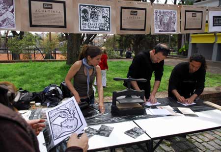 Uruguayan youths create prints with a vintage printer beside a visual art museum in Montevideo, Uruguay, Oct. 4, 2008.