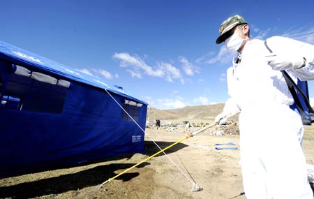 A staff member sprays medicine for epidemic prevention near tents at Yangyi Village in Gedar Township of Damxung County in southwest China&apos;s Tibet Autonomous Region, on Oct. 7, 2008. A 6.6-magnitude earthquake jolted Damxung County near Lhasa at 4:30 p.m. (Beijing Time) on Oct. 6. The epidemic prevention is now under way in quake-hit areas. [Xinhua] 