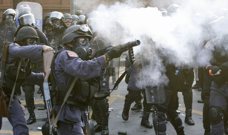 Riot policemen fire tear gas towards anti-government demonstrators protesting outside Parliament in Bangkok October 7, 2008. Thai riot police clashed with protesters in the capital on Tuesday, injuring more than 380 people. [Agencies]