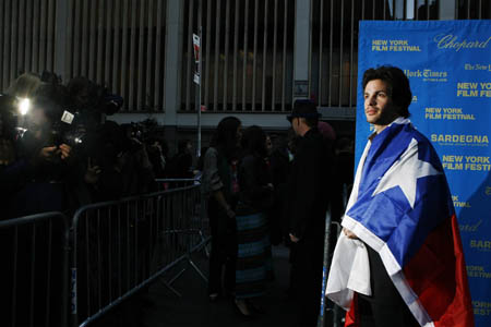 Chilean actor Santiago Cabrera drapes a Chilean flag over himself as he arrives for the New York Film Festival premiere of 