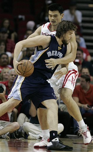 Memphis Grizzlies' Mark Gasol goes to the basket defended by Houston Rockets' Yao Ming during a preseason NBA basketball game on Tuesday in Houston.