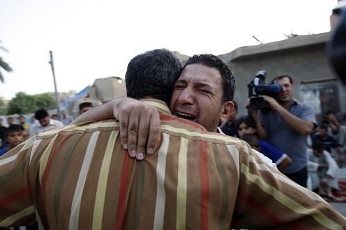 The brother and another relative of assassinated Iraqi anti-American Sadrist member of parliament Saleh al-Okaili (al-Ogayly) weep as they await the coffin containing Okaili's (al-Ogayly's) remains at his family home in Baghdad's Sadr City on October 9, 2008. Okaili (Ogayly) was assassinated in a bomb attack today in Baghdad's Shiite stronghold of Sadr City, marking the first killing of a MP in 18 months, his radical Sadrist faction said. [Xinhua]
