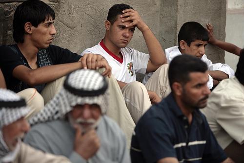 Friends and relatives of assassinated Iraqi anti-American Sadrist member of parliament Saleh al-Okaili (al-Ogayly) mourn as they await the cofin containing Okaili's (al-Ogayly's) remains at his family home in Baghdad's Sadr City on October 9, 2008. Okaili (Ogayly) was assassinated in a bomb attack today in Baghdad's Shiite stronghold of Sadr City, marking the first killing of a MP in 18 months, his radical Sadrist faction said. [Xinhua]