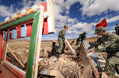 Soldiers help local villagers clean debris in Yangyi Village of Gedar Township in Damxung County, an outer county of Lhasa, capital of southwest China&apos;s Tibet Autonomous Region, Oct. 10, 2008.
