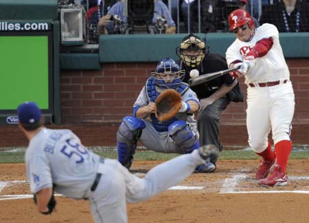 Philadelphia Phillies Carlos Ruiz hits an RBI double off of Los Angeles Dodgers pitcher Chad Billingsley (front) as catcher Russell Martin (back) looks on during the second inning in Game 2 of Major League Baseball's NLCS playoff series in Philadelphia October 10, 2008. [Xinhua Photo]