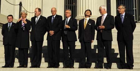 G7 finance ministers pose for a group photo after their meeting at the Treasury Department in Washington, The United States, October 10, 2008. (L-R) are: Jim Flaherty of Canada, Christine Lagarde of France, Peer Steinbrueck of Germany, U.S. Treasury Secretary Henry Paulson, Italy's Economy Minister Giulio Tremonti, Shoichi Nakagawa of Japan, Britain's Chancellor of the Exchequer Alister Darling and Eurogroup Chairman Jean-Claude Juncker.[Zhang Yan/Xinhua] 