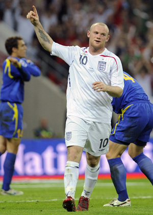 England's Wayne Rooney (C) celebrates as Kazakhstan's Alexandr Kuchma (R) reacts with teammate Yuriy Logvinenko after scoring an own goal during their 2010 World Cup qualifying soccer match at Wembley Stadium in London October 11, 2008.