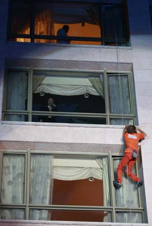 French 'Spiderman' Alain Robert climbs the facade of the InterContinental Hotel Phoenicia while guests watch him in Beirut October 11, 2008.