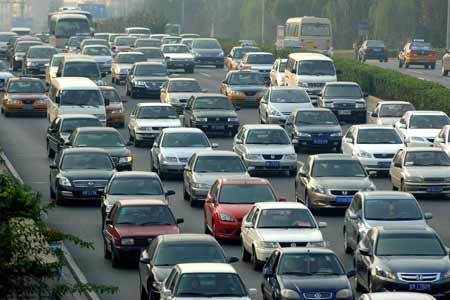 Cars run on the Second Ring Road in Beijing, capital of China, Oct. 13, 2008. A new traffic restriction went into effect officially in Beijing on Monday, which is expected to help sustain the hard-won smooth traffic and good air quality during the Olympic Games.