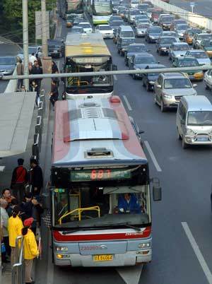 People get on a bus at a bus stop in Beijing, capital of China, Oct. 13, 2008. [Xinhua] 