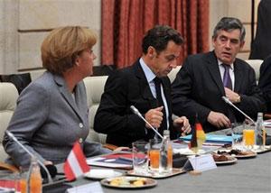 German Chancellor Angela Merkel, left, French President Nicolas Sarkozy, center, and British Prime Minister Gordon Brown, right, attend a financial crisis summit gathering Eurogroup heads of state and government at the Elysee Palace in Paris Sunday, Oct. 12, 2008.