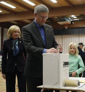 Conservative leader and Canada's Prime Minister Stephen Harper casts his ballot in Calgary, Alberta October 14, 2008. Also pictured are his wife Laureen and daughter Rachel. Canadians will head to the polls Tuesday in a federal election. [Chris Wattie/REUTERS] 