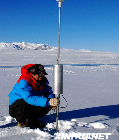 A scientist sets up research equipment at the snow-covered origin area of Tuotuo River, in the remote reaches of Mt. Tanggula on the Tibetan Plateau, October 12, 2008. 