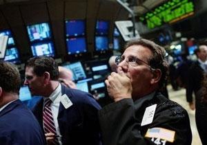 Traders work the floor at the New York Stock Exchange. Wall Street stocks plunged on heightened recession fears Wednesday, as panic returned to global markets. [Chris Hondros/Getty Images/AFP] 