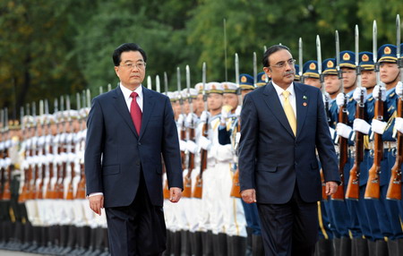 Chinese President Hu Jintao greets his Pakistani counterpart Asif Ali Zardari during a welcoming ceremony attend a ceremony at the Great Hall of the People in Beijing October 15, 2008. Zardari arrived on Tuesday for his first visit to China as president and highlighted the historic friendship between the two countries in a meeting Wednesday and pledged to push forward with their all-round partnership. [Agencies]