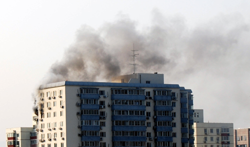 Nearly 100 firefighters fought for two hours to extinguish a blaze at a Beijing apartment building on Thursday afternoon.