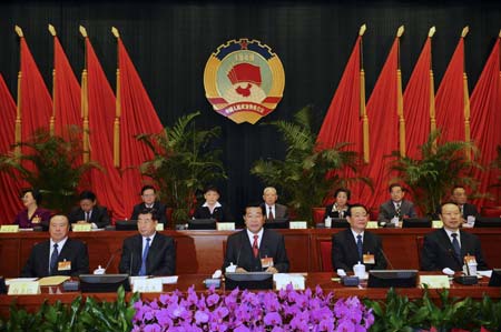 Jia Qinglin (C), chairman of the National Committee of the Chinese People's Political Consultative Conference (CPPCC), addresses the opening session of the 3rd meeting of the standing committee of CPPCC's 11th national committee in Beijing, capital of China, on Oct. 15, 2008.[Li Tao/Xinhua]