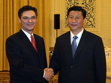 Chinese Vice President Xi Jinping (R) shakes hands with Patrick Devedjian, general secretary of French Union for a Popular Movement (UMP), in Beijing, capital of China, on Oct. 17, 2008.