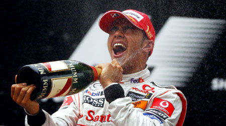 Mclaren-Mercedes team's Lewis Hamilton of Britain sprays champagne to celebrate his victory during the F1 Chinese Grand Prix at the Shanghai International Circuit in Shanghai, east China, on Oct. 19, 2008. [Fan Jun/Xinhua]