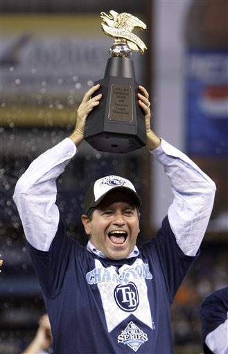 Tampa Bay Rays owner Stuart Sternberg holds up the championship trophy after defeating the Boston Red Sox to win the American League baseball championship series in St. Petersburg, Fla. yesterday.