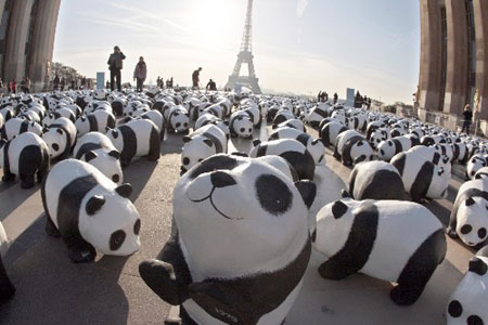 A panda parade : Paper mache pandas set up by members of the World Wildlife Fund are pictured on the Parvis des droits de l'Homme at Paris Trocadero esplanade to symbolize the 1,600 pandas left on earth and to call people to do their part in helping to reverse the deterioration of our natural environment.[Xinhua/AFP] 