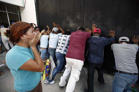 Relatives of inmates try to tear down the main gate of a jail as a form of protest against prison authorities for not giving the names of inmates wounded or dead in a riot in the border city of Reynosa, northern Mexico October 20, 2008. At least 21 prisoners died in a jail riot in Mexico near the Texas border on Monday when inmates from rival gangs staged a gun battle and set fire to the building.