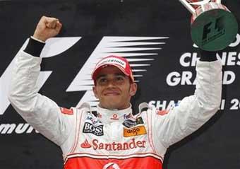 McLaren Mercedes driver Lewis Hamilton of Britain celebrates on the podium after winning the China Formula One Grand Prix at the Shanghai International Formula One Grand Prix circuit, in Shanghai, China.[AP Photo]   