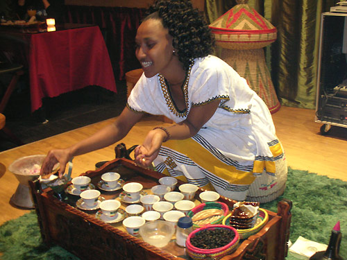 A young Ethiopian woman dressed in traditional costume performs an Ethiopian coffee ceremony in Beijing's First Ethiopian Restaurant on October 17, 2008. [Photo: CRIENGLISH.com] 
