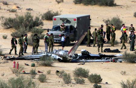  Israeli military personnel check the site of the training plane crash in the northern Negev Desert near Kibbutz Tzeelim, Isreal, Oct. 22, 2008. A military training plane crashed in southern Israel on Wednesday, killing an Israel Air Force (IAF) officer and a soldier. (Xinhua/Tsafrir Abayov) 