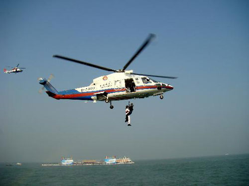 A helicopter rescues a victim during a joint search-and-rescue exercise held between coastal city Xiamen on the mainland and the island of Jinmen in Taiwan on Thursday, October 23, 2008. This is part of the first ever aero-amphibious search-n-rescue exercise held across the Straits since the opening of a direct shipping link between Xiamen and Jinmen.[Photo: Xinhua] 
