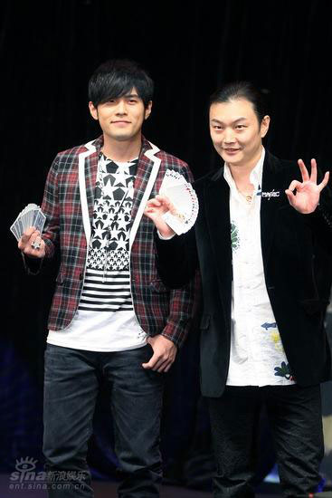 Jay Chou plays poker tricks with a magician on stage during a press conference in Beijing to promote his new album 'Capricorn' on Thursday, October 23, 2008.