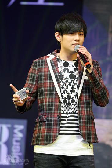 Jay Chou plays poker tricks on stage during a press conference in Beijing to promote his new album 'Capricorn' on Thursday, October 23, 2008.