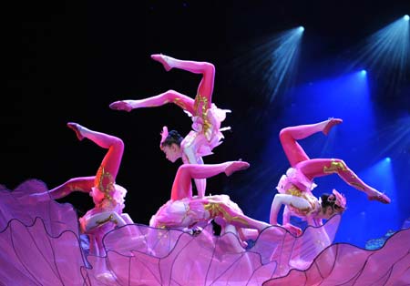 Actresses perform acrobatics during a performance called 'The Night of Southeast Asia', which is a part of the Nannning International Folk Song Arts Festival, in Nanning, capital of southwest China's Guangxi Zhuang Autonomous Region, Oct. 23, 2008.