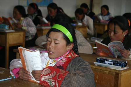 Students read books in the classroom of the Lajia girl school in Golog Tibetan Autonomous Prefecture of Qinghai Province on Oct. 17, 2008. The girl school founded in 2005 has made more than 300 Tibetan girls fulfill their 