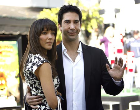 Cast member David Schwimmer, who gives voice to Melman, poses with actress Zoe Buckman at the premiere of 