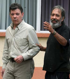 Colombia&apos;s Defense Minister Juan Manuel Santos, left, walks along with Former Colombian congressman Oscar Tulio Lizcano at a military base in Cali, Colombia, Sunday, Oct. 26, 2008.