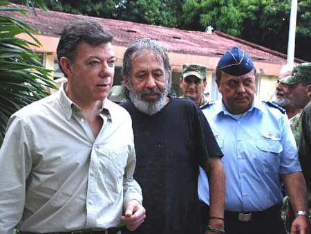 Colombia&apos;s Defense Minister Juan Manuel Santos, left, former hostage Oscar Tulio Lizcano, center, and Air Force commander Gen. Jorge Ballesteros, arrive at a military base in Cali, Colombia, Sunday, Oct. 26, 2008.