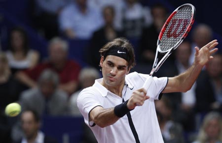 World's number one player, Switzerland's Roger Federer prepares to serve a  ball against Argentina's David Nalbandian (unseen) during the opening match  for the Shanghai Tennis Masters Cup held at the Qi Zhong