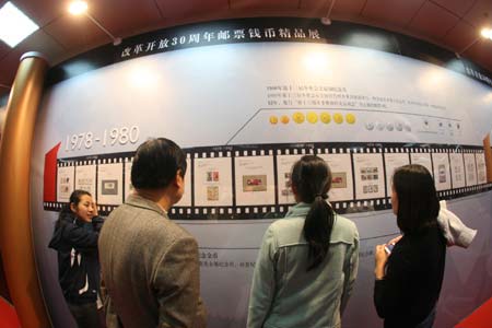 Visitors view collections of stamps during International Stamps and Coins Exposition held in Beijing, Oct. 24, 2008. The exposition was opened here on Friday with collections of stamps, coins and souvenir badges from all over the world exhibited.[Xinhua Photo/ Chen Xiaogen]