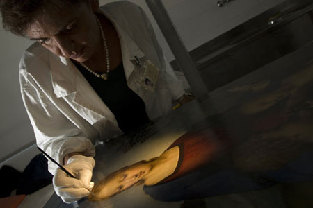 Fine arts technician Patrizia Riitana demonstrates the process in which Italian artist Raphael's 1506 oil-on-wood painting 'Madonna of the Goldfinch' was restored at a laboratory in Florence October 23, 2008. 