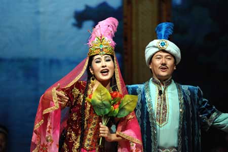 Actors from China&apos;s Xinjiang Mukam Art Troupe show Chinese ethnic culture during their performance in Doha, Qatar, Oct. 26, 2008. 