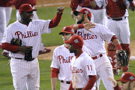 Philadelphia Phillies Ryan Howard (L) slaps hands with Pedro Feliz (R) after they defeated the Tampa Bay Rays in Game 4 of Major League Baseball's World Series in Philadelphia October 26, 2008. 